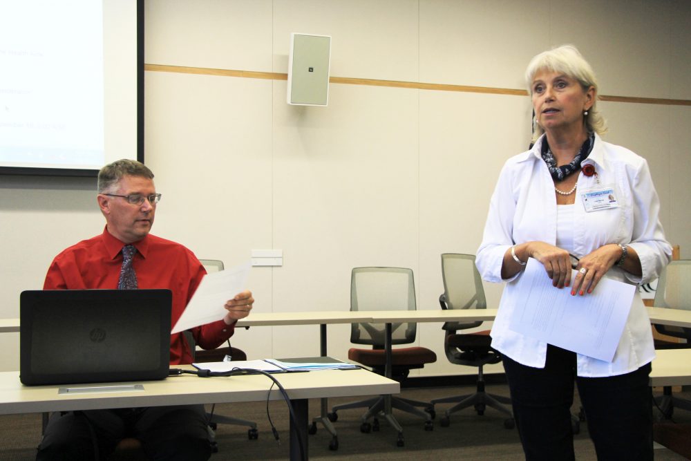 Professor Julie Blaney (right) gives her proposal for creating a Certified Nurse Assistant & Home Health Aid department separate from the Nursing Department to the board of the American River College Academic Senate as President Gray Aguilar (left) reads the proposal at their September 8, 2016 meeting. (Photo by Robert Hansen)