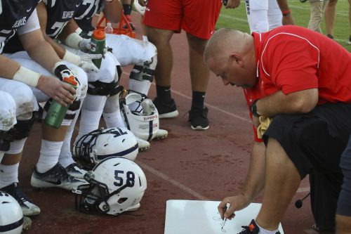 ARC Offensive Assistant Josh Crabtree draws out a play to the football players in the game against CCSF on Sept. 17. (Photo by Laodicea Broadway)