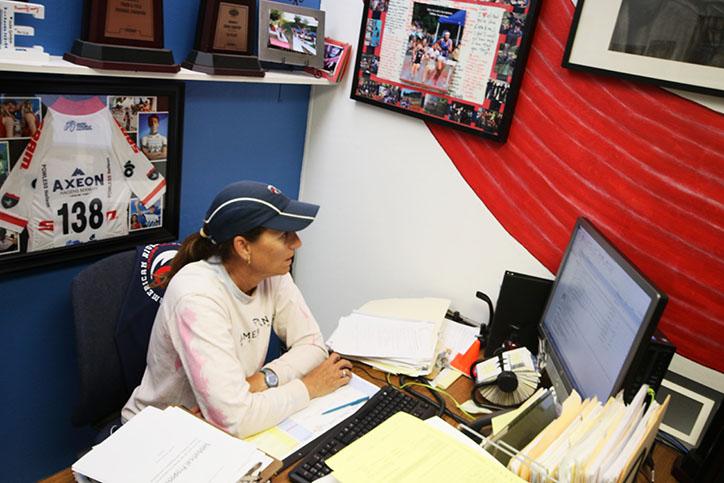 Jeantte Powless, the womens cross country coach, prepares the itinerary for their cross country meet, Lou Vasquez, at Golden Gate Park in San Francisco at 3:30 p.m. (Photo by Cheyenne Drury)