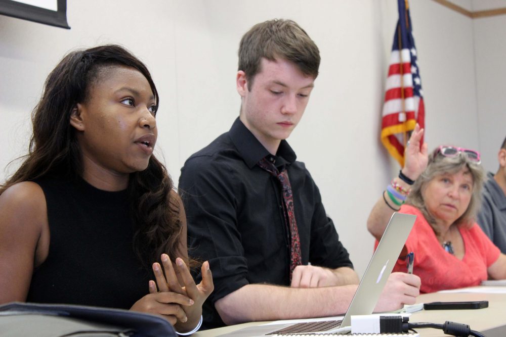 Senate President Valencia Scott (left) discusses the fomation of the judiciary committee as Justin Nicholson listens and Laurie Jones waits to be called on at the first senate meeting of the fall semester on Sept. 1. (Photo by Robert Hansen)