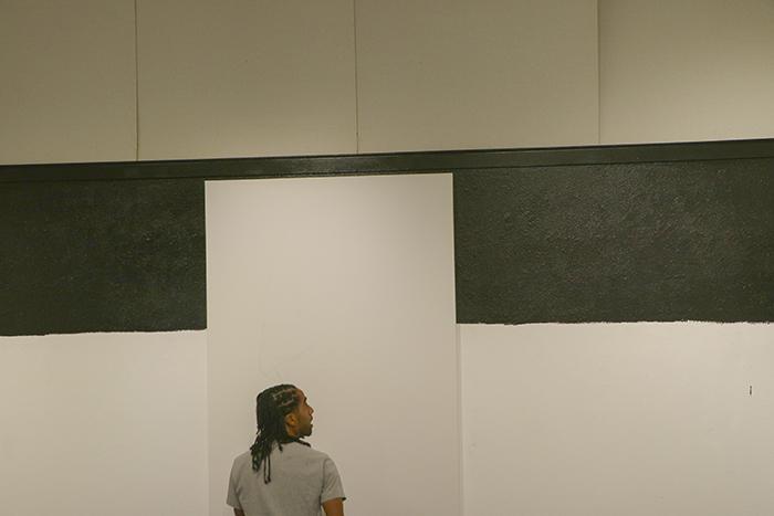Unity Lewis planning out his artwork in the Kaneko Gallery