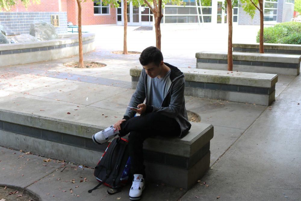 ARC student Jack Simmons using his smartphone next to the Liberal Arts breezeway, October 13, 2016. 