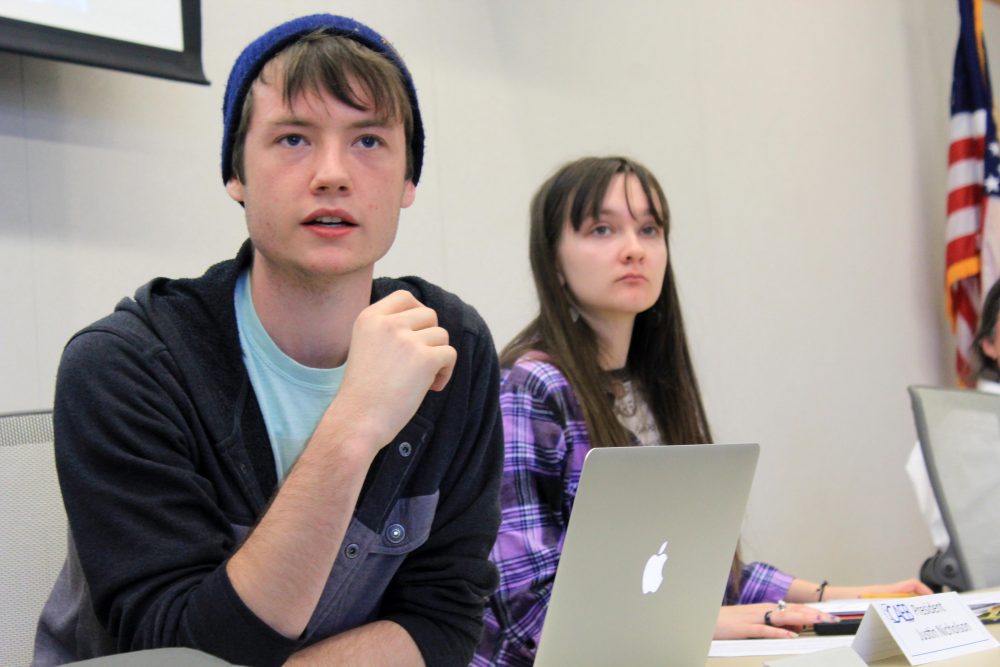 Clubs and Events Board President Justin Nicholson (left) with vice president Mary Stedman (right) listen to the board discuss the theme for next semesters Murder Mystery Dinner at the Oct.11 meeting.  (Photo by Robert Hansen)