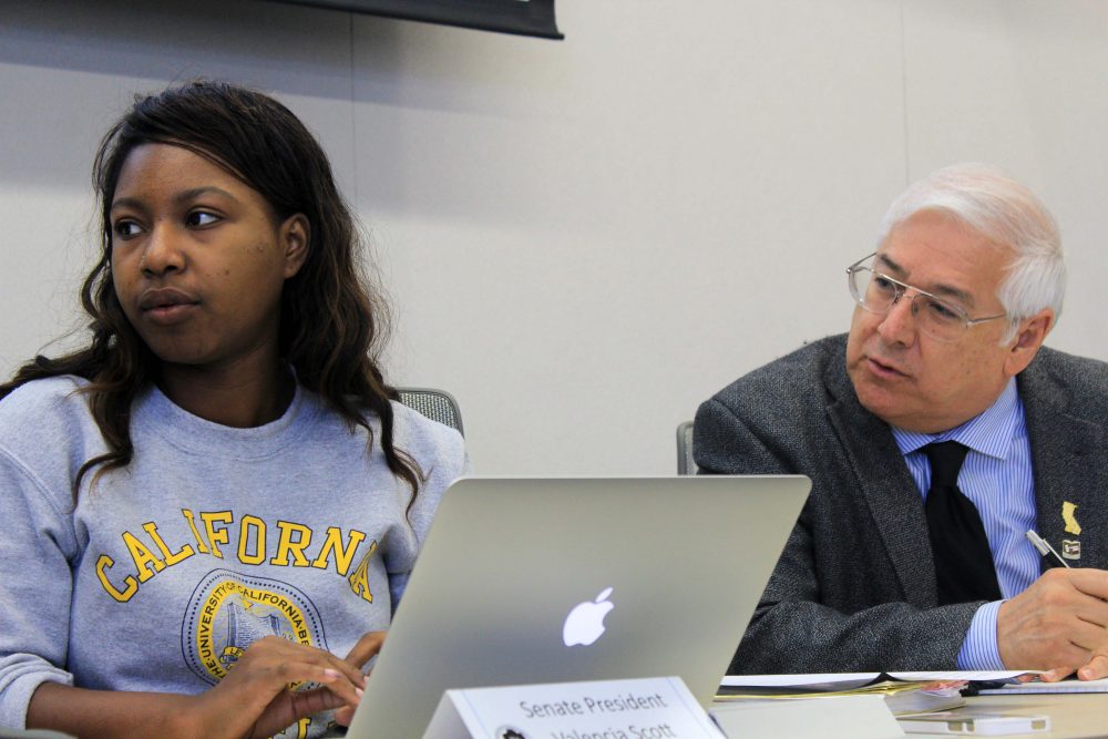 American River College student senate president Valencia Scott (left) and Parliamentarian Lorenzo Cuesta (right) listen to discussion at the October 13, 2016 meeting in the board room. (Photo by Robert Hansen)