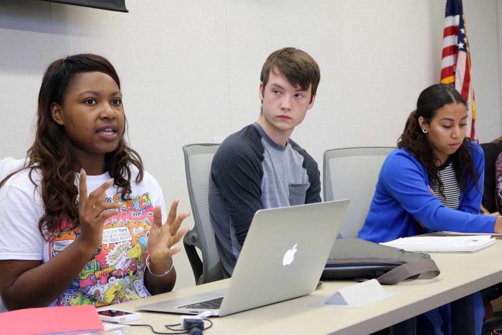 American River Coleege student Senate president Valencia Scott (left) with Justin Nicholson (center) and Alejandra Hilbert (right) gives hear opening message at the October 6, 2016 meeting. (Photo by Robert Hansen)