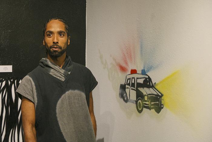 Artist Unity Lewis explains to a crowd of onlookers the meaning behind some of his murals in the Kaneko Art Gakllery at American River College on Oct. 11 (Photo by Luis Gael Jimenez)