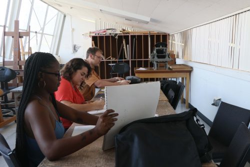 American River College art students Aerial Sudds, Erica Campbell, and Max Marchol work on their school art projects in the new art loft next to the Kaneko Gallery.  (Photo by Lidiya Grib)