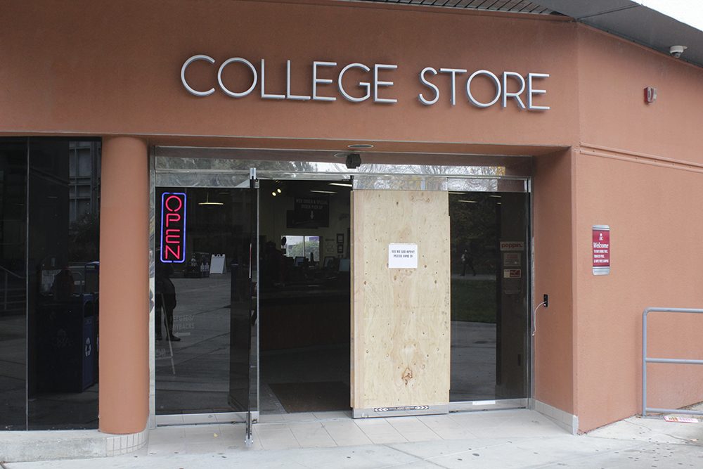 The Beaver Bookstores front door, replaced by a plank of wood after the store was vandalized. The store was vandalized early Friday morning. (Photo by Hannah Darden)