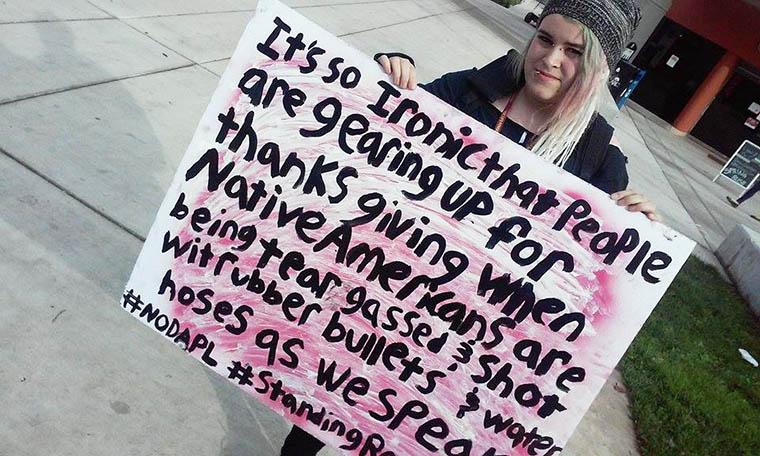 ARC student Alana protests the Dakota Access Pipeline  outside of the bookstore today. (Photo by Mychael Jones)