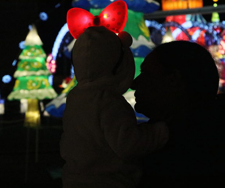 A woman looks at the child she is holding at “Global Winter Wonderland” at Cal Expo on Sunday in Sacramento, Calif. (Photo by Cheyenne Drury)