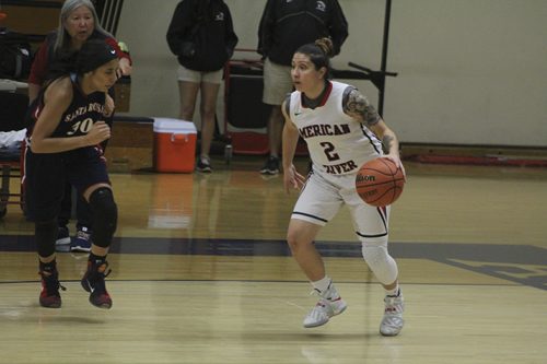 American River College guard Rauline Martinez is marked by Santa Rosa forward LaDonna Saint Louis while dribbling the ball upcourt during a game on Jan. 27, 2017 at ARC. ARC won the game 62-44. (Photo by Mack Ervin III)