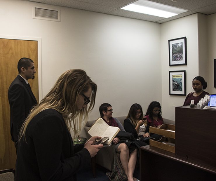The students wait outside the office of Assemblymember Ken Cooley. They are going over their notes and practicing what they are going to say. (Luis Gael Jimenez)
