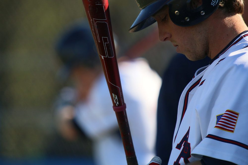 ARC baseball player holds the bat.