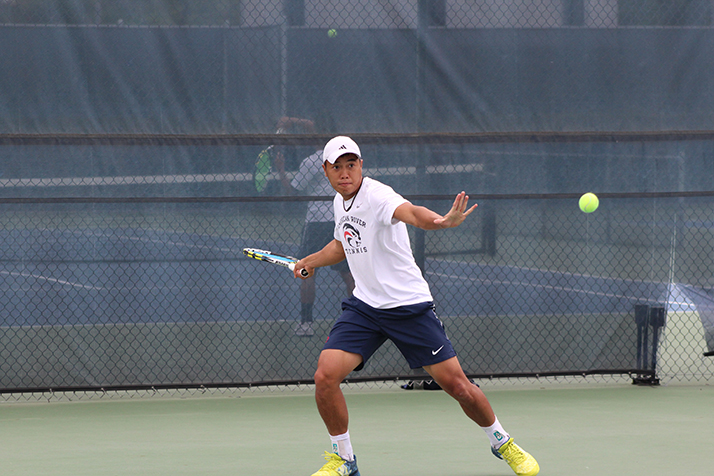 American River College sophomore Tam Duong hits the ball back across the net during a game against Modesto Junior College on Apr. 11, 2017. Duong won his match 6-1, 6-1 as ARC advanced to the semifinals of the NorCal tournament. (Photo by Mack Ervin III)