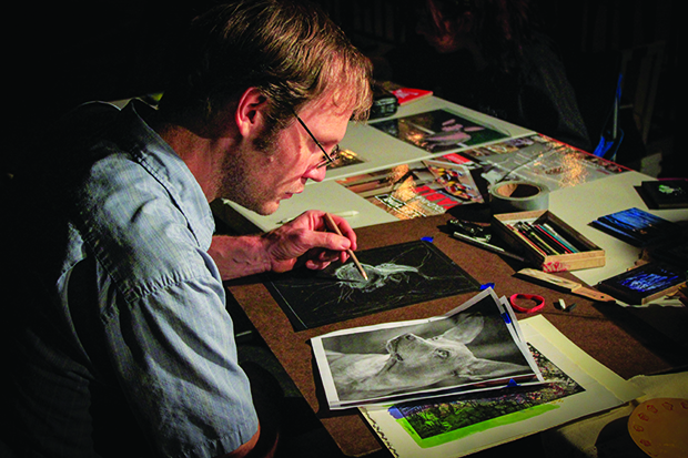 Max Marchol draws a portrait of a dog from a photo at the Oak Park Brewing Company  on Sept. 6 in Sacramento, California. (Photo by Hannah Darden)