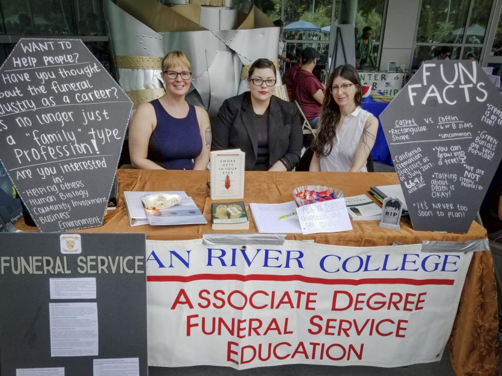 Members of the Funeral Services Department at American River College sit at a booth for “Welcome Day,” on Sept. 7, 2017. (Photo by Hannah Yates)