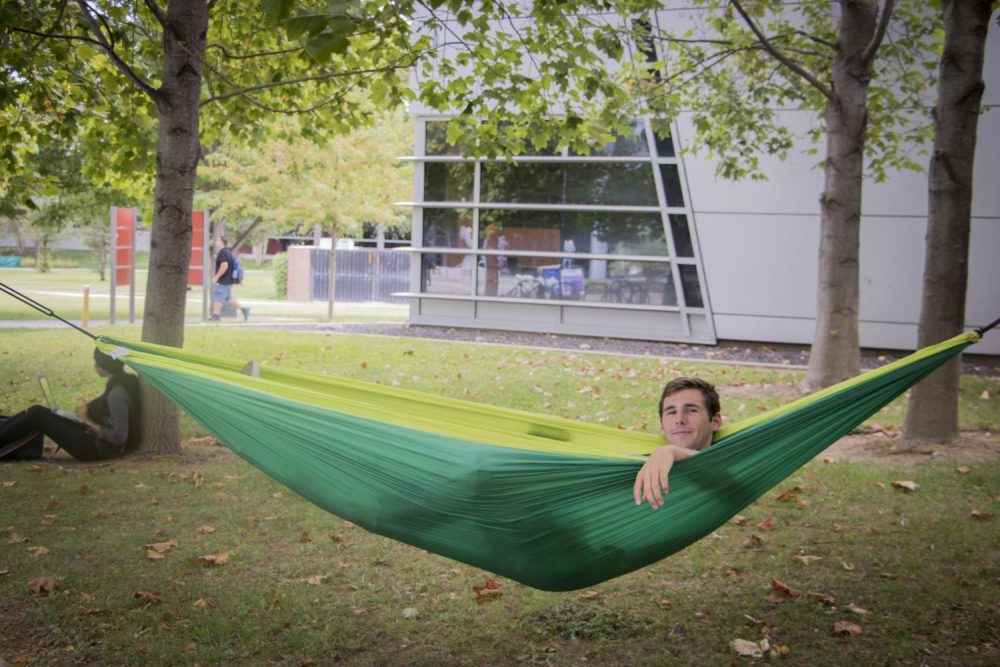 David Cocker lays in a hammock at American River College on Sept. 20, 2017. (Photo by Ashley Hayes-Stone)