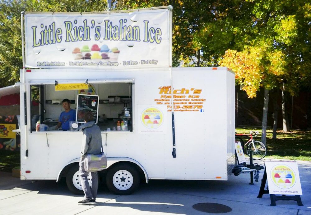 A student buys a Italian ice cream from Little Richs Italian Ice at American River College at Sacramento, California. (Photo by John Ennis)