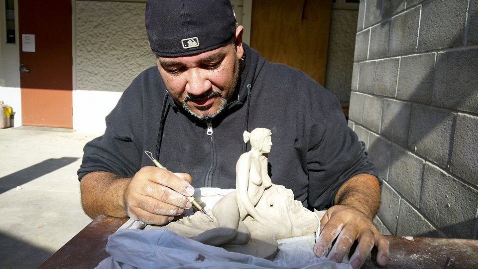 Manuel Marmolejos is working on his sculpture during his Figure Sculpting 375 class at American River College on Nov. 21. (photo by Ashley Hayes-Stone)