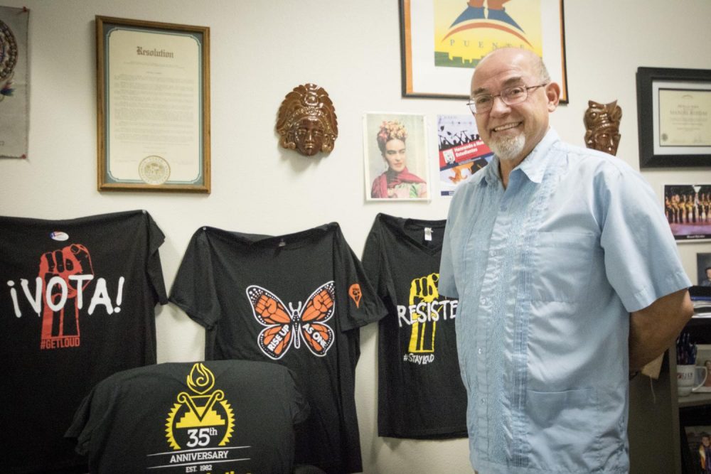 Counselor Manuel Ruedas stands next to the decorative wall in his office at the HUB on Nov. 12. Ruedas works with the Puente Program to help disadvantaged students achieve academic success. (Photo by Ashey Hayes-Stone)