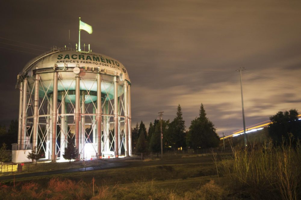 The Sacramento Water Towers illuminated by drivers on Interstate 5 on Nov. 13. The Welcome to Sacramento water tower sits in the Pocket-Greenhaven neighborhood. (Photo by Luis Gael Jimenez)