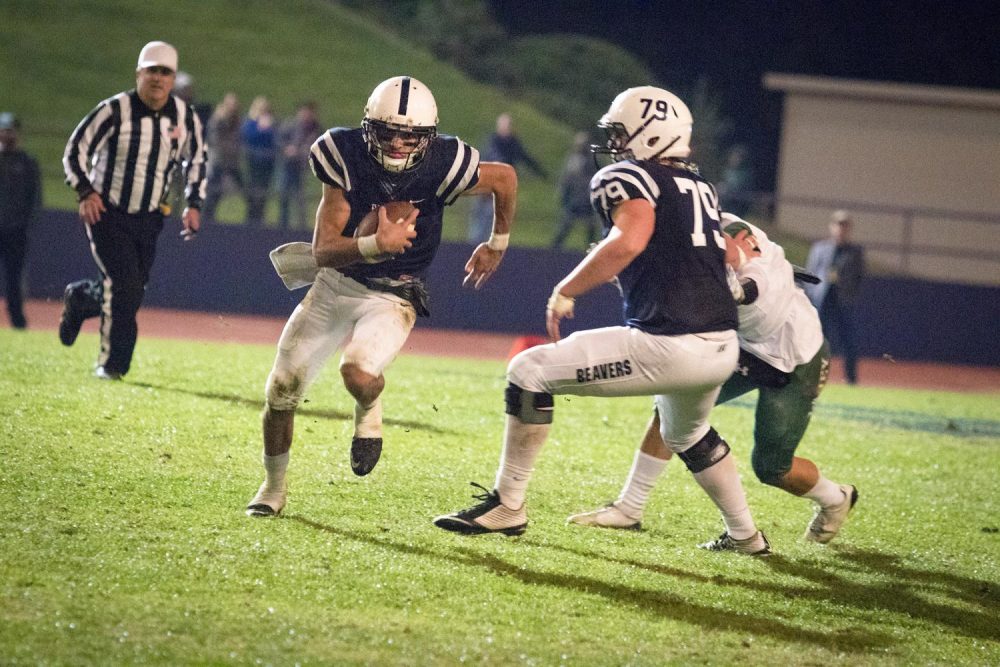 Quarterback Hunter Rodrigues scrambles for a first down during American River College’s 41-35 win over Laney College on Nov. 18. (Photo by Ashley Hayes-Stone)