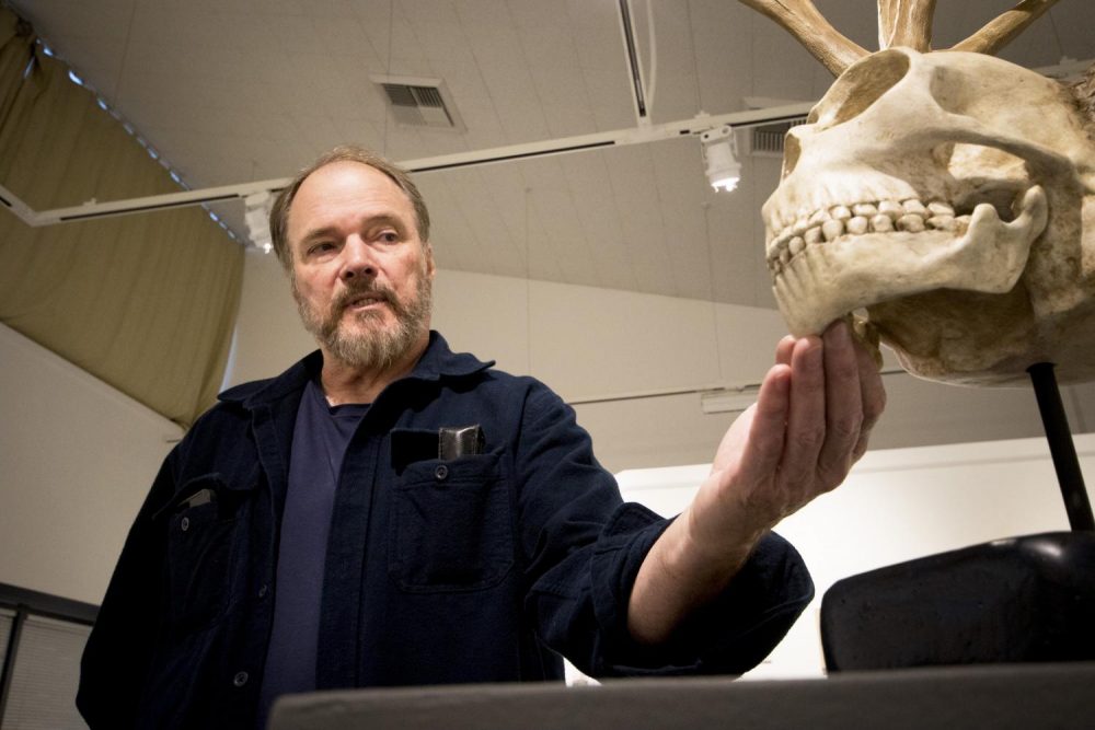 American River College Professor Craig Schindler examines his piece John Dee in the Kaneko Gallery on Nov. 6. (Photo by Ashley Hayes-Stone)