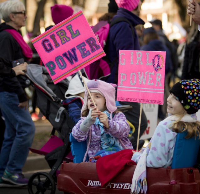 Young protesters wave their signs during the 2018 Women’s March at Southside park on Jan. 20 in Sacramento, California.