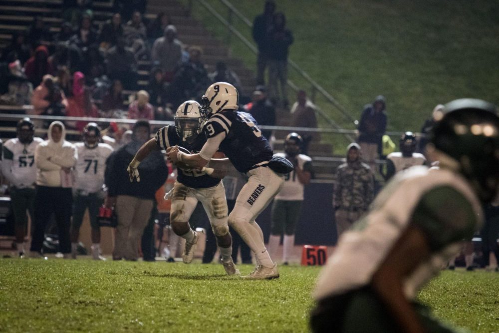 Peyton Wifley (#9)hands-off the ball to running back Ish Perez (#28) during a game against Laney College on Nov. 18. (Photo by Ashley Hayes-Stone)