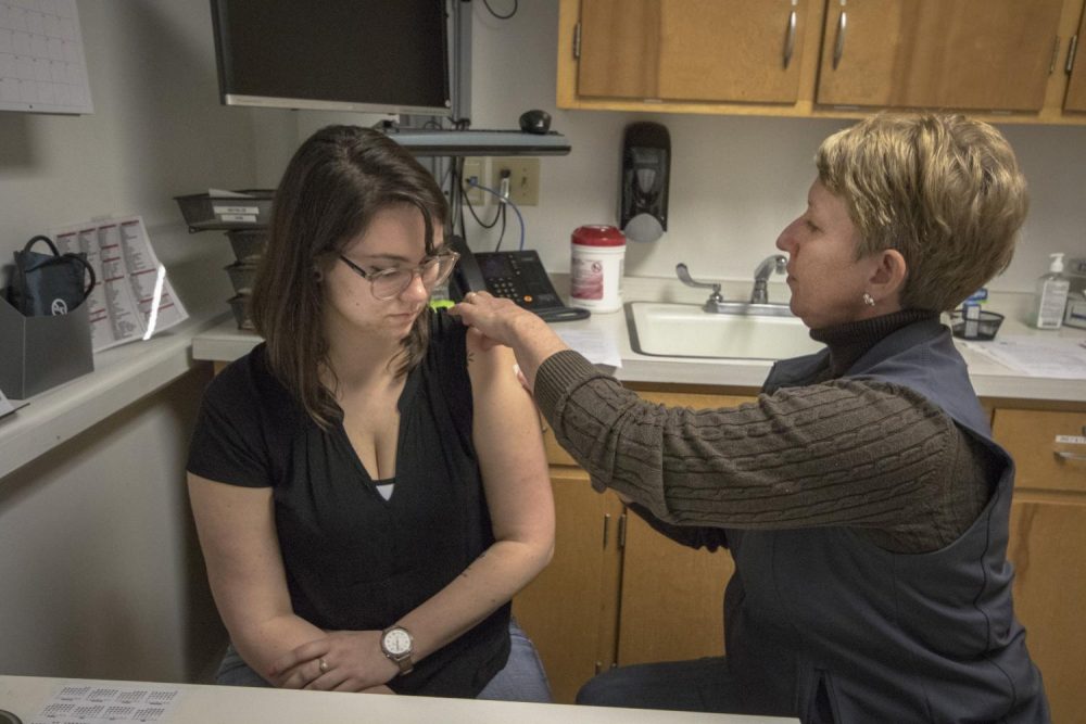 Writer Jennah Booth receives a flu shot from American River College Nurse Pam Whipple on Feb. 1 in Sacramento, California. Booth opted to get the flu shot after researching preventative care measures. (Photo by Ashley Hayes-Stone)