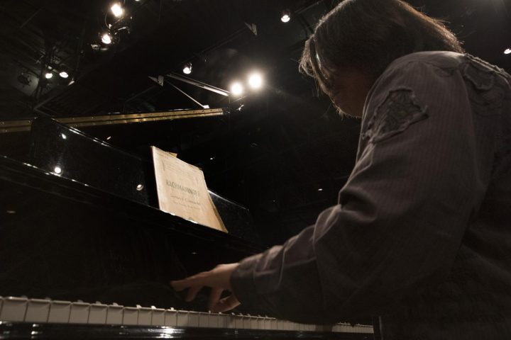 Kyle Cremat plays the piano during rehearsal on Mar. 8 at American River College.(Photo by Ashley Hayes-Stone)
