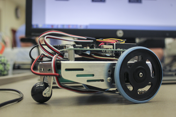 A student built robot sits on a desk during an electronics technology midterm on Feb. 28 at ARC. Students had to build a robot from a kit that would follow a black line along the ground. (Photo by Mack Ervin III)