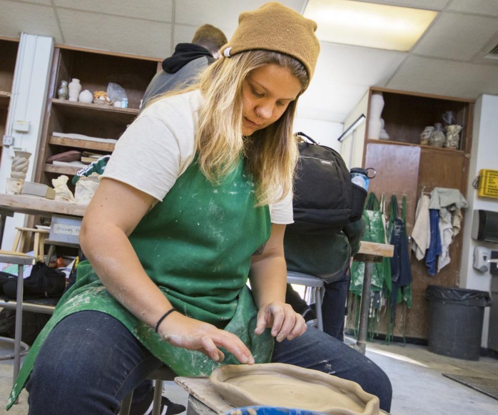 Ceramic student Taylor Bacon uses the wheel to create a plate on Nov. 7, 2017 at American River College. (Photo by Ashley Hayes-Stone)