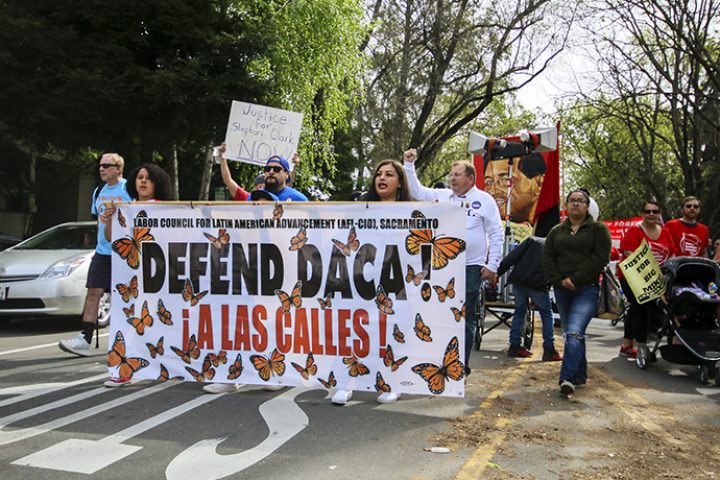 Signs and banners reading “defend DACA’ were held during the Cesar Chavez march on  March 31, 2018.  (photo by Brienna Edwards)