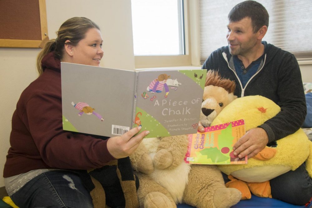 American River Colleges Childhood Development Center employees Jennifer Lewin and Vasyl Ivanov read to each other on April 6, 2018. (Photo Illustration by Ashley Hayes-Stone)