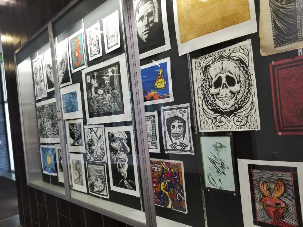 The students’ artwork hangs on the wall in the Life Science and Fine Art building at American River College on April 9. (photo by Hannah Yates) 
