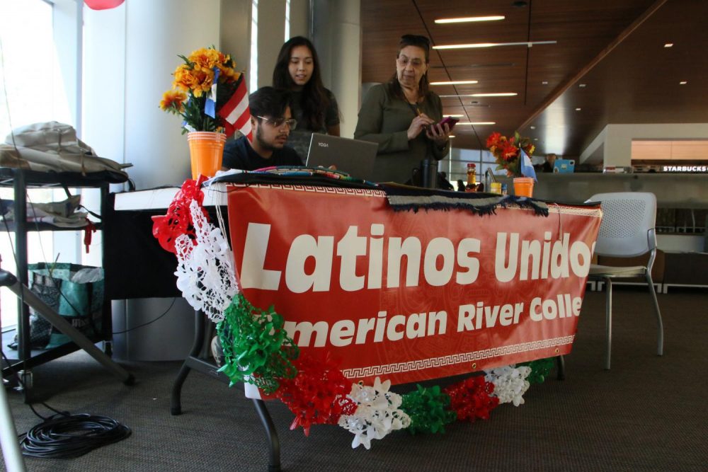 Members of Latinos Unidios at American River College behind an information booth regarding Cinco De Mayo on April 24, 2018. (Photo by Michael Pacheco)