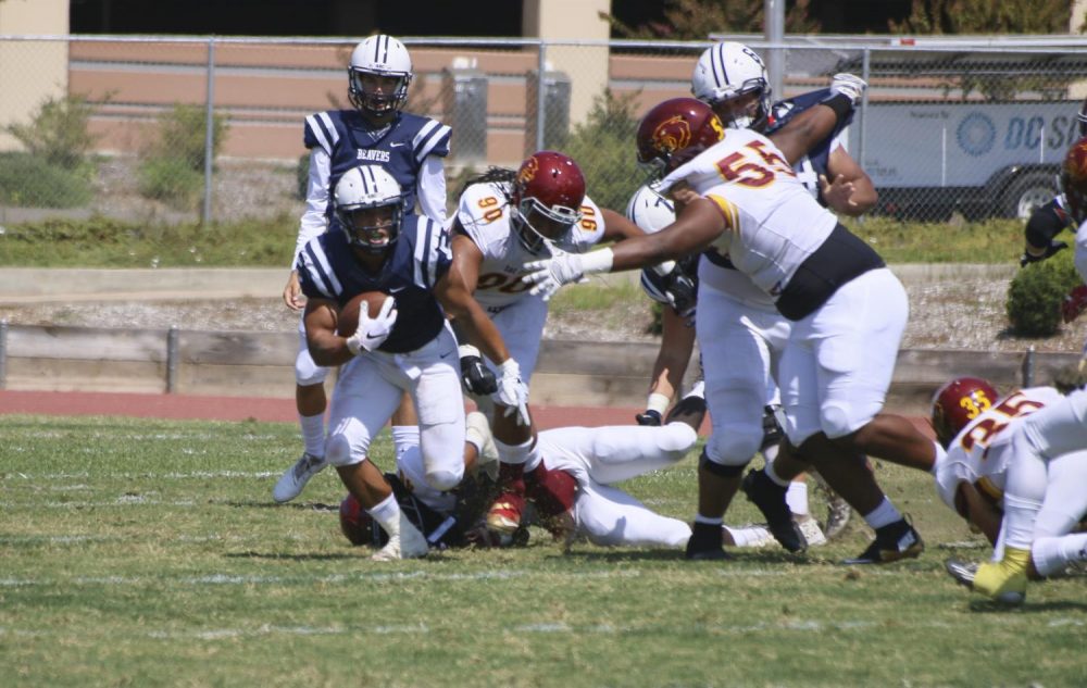 American River College running back, Evyn Holtz dodges the Sacramento City College defence in the first quarter of the game on Sept. 1, 2018. (Photo by Jennah Booth)
