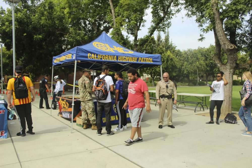 Tyler Heines, theater major, practices walking a straight line before wearing drunk simulation goggles, in front of the library at American River College on Sept. 12, 2018. The Los Rios Police Department and California Highway Patrol brought the goggles and tricycles to campus to raise awareness about the dangers of drunk driving. (Photo by Itzin Alpizar)