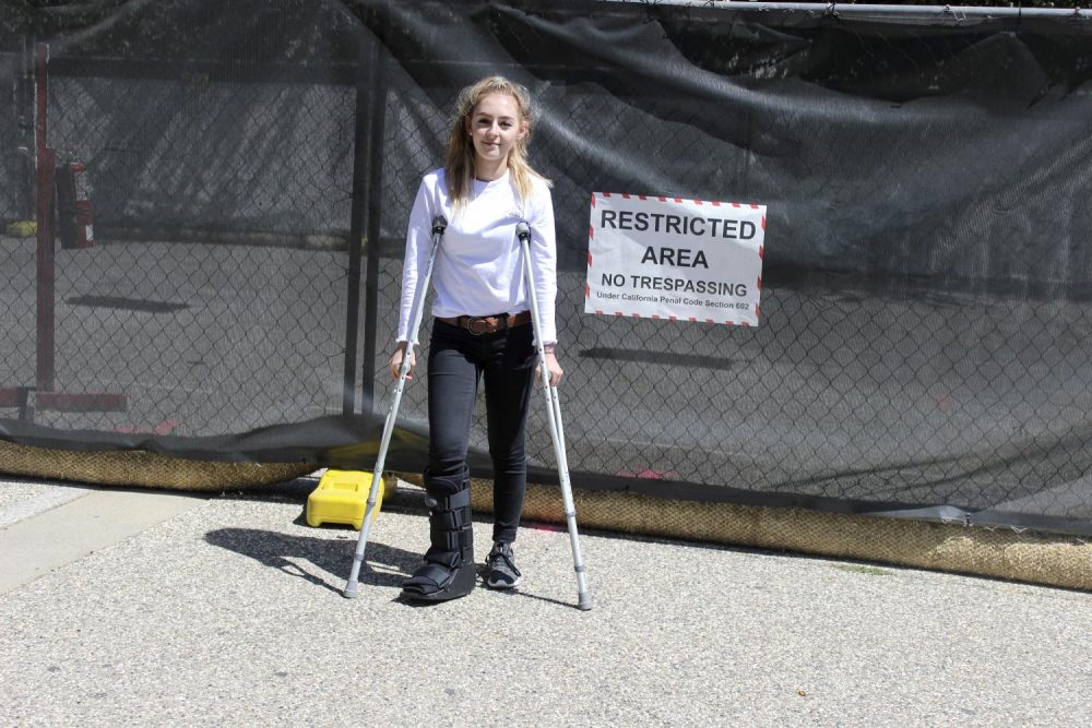 Taylor Ryan, a student at American River College whose major is undecided, stands holding crutches in front of the fencing around the construction on Sept. 13, 2018. Navigating around the site has been challenging for students with disabilities and other accommodations. (Photo by Hameed Zargry)