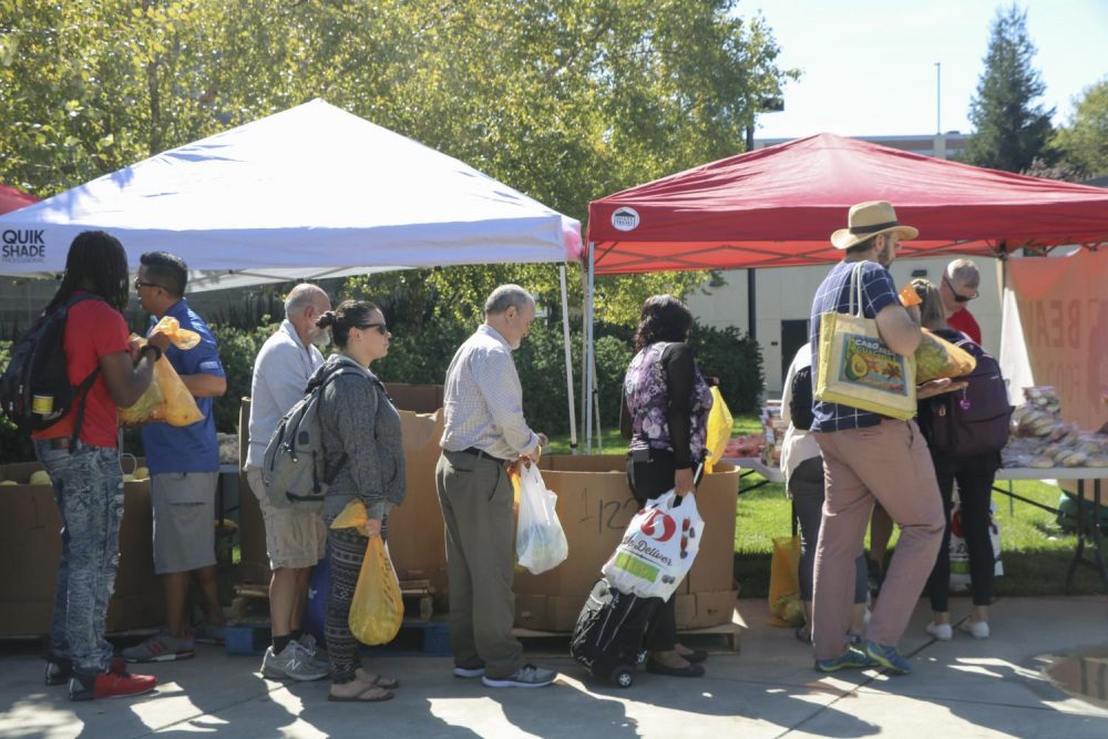 American River College students and members of the campus community line up to get free produce and bread at the Beaver Food Pantry on Sept. 26, 2018. The food pantry will be available until 3 p.m. today In front of the gym ticket window. (Photo by Itzin Alpizar)