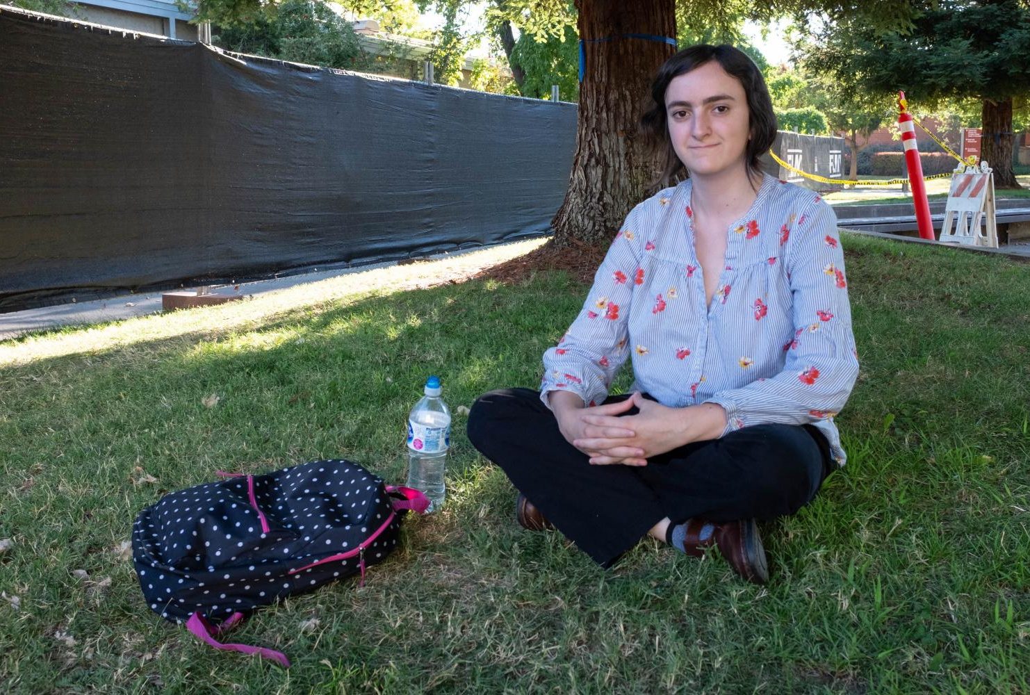 Undecided major, Cecily Cuny studies in the shade of a tree wearing a floral print shirt and black slacks at American River College on Sept. 6. “I like flower print shirts, loose things since it’s so hot out. Usually, I just go with what’s the most comfortable,” Cuny said. (Photo by Patrick Hyun Wilson)