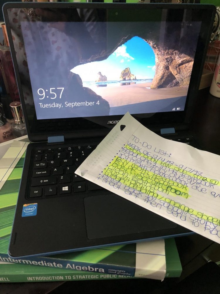 My laptop resting on with my textbooks and to-do list.