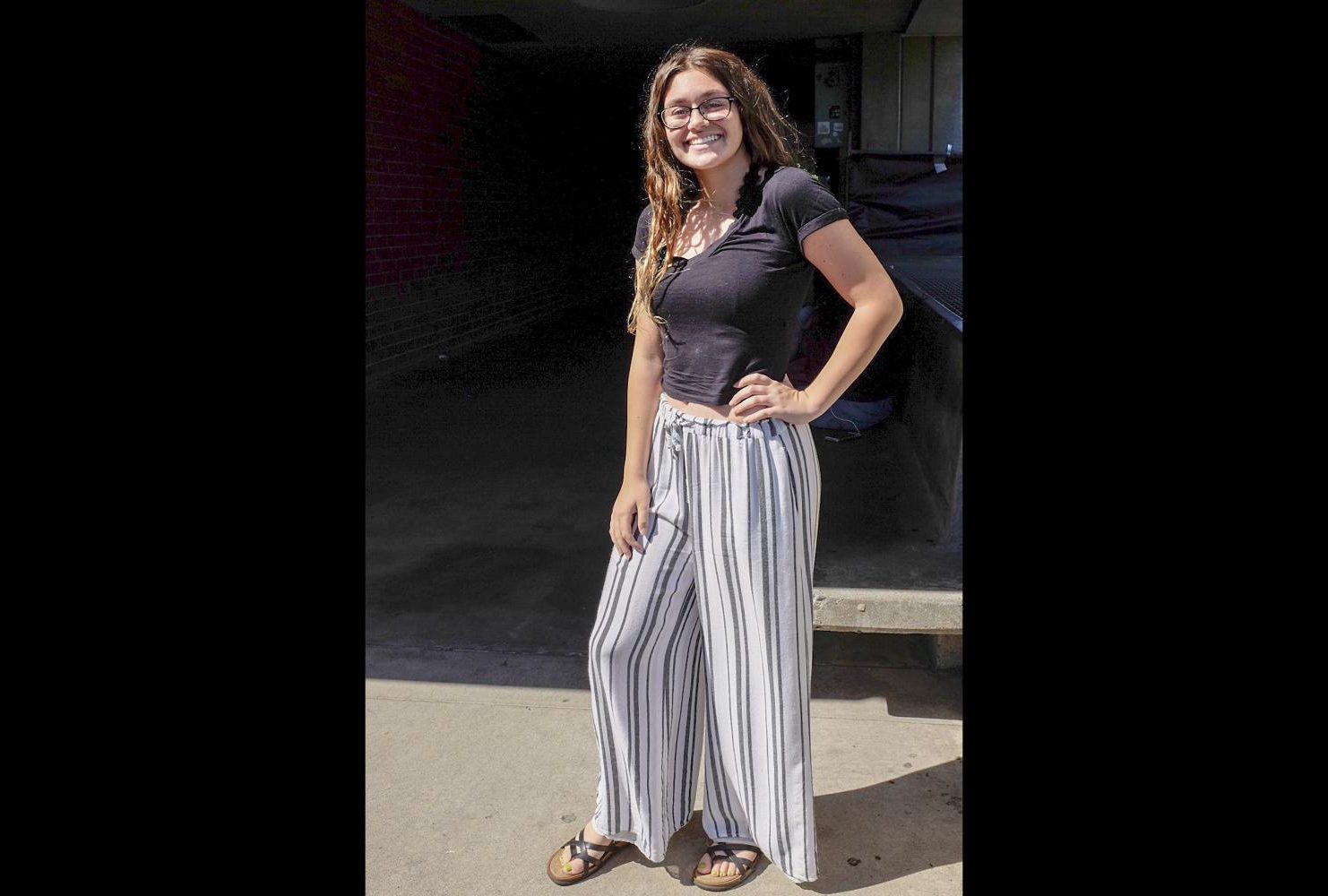Geography major, Madison Rosen wears loose fitting striped slacks and a black crop top with open toed sandals on Aug. 29. “These look like pajamas honestly but they’re cute and comfy… My mom likes to think I dress bohemian kind of, kind of hippie,” Rosen said. (Photo by Patrick Hyun Wilson)