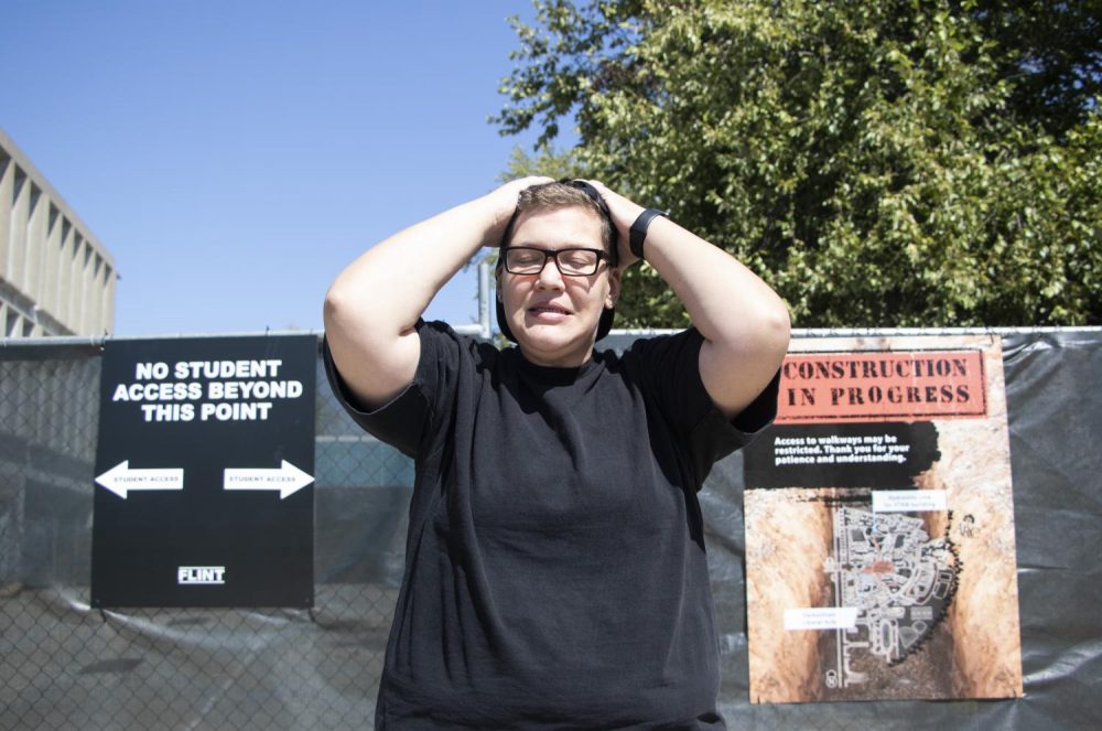 Opinion editor Tracy Holmes poses in front of the gated-off Liberal Arts building during construction at American River College on Sept. 10, 2018. (Photo Illustration by Ashley Hayes-Stone)
