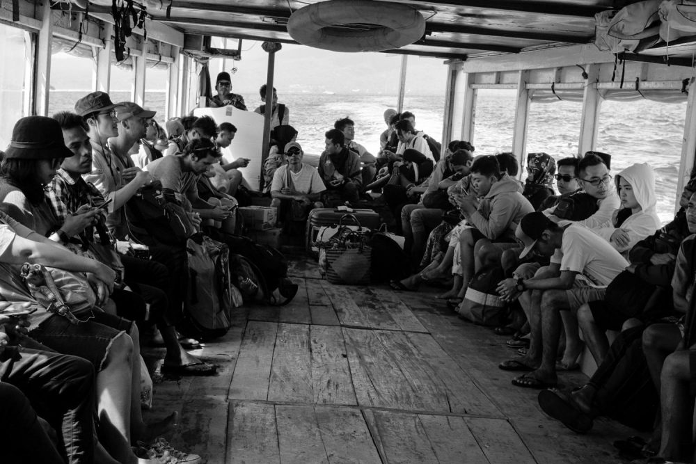 This photograph is used to question the narrative possibility in photography. Depicted in the photo are a group of people, in a barge, on a body of water, but is there really a narrative? (Photo by Patrick Hyun Wilson)