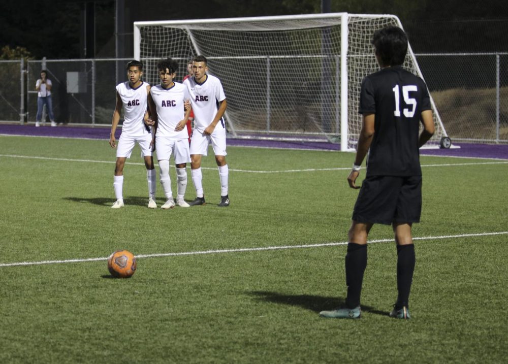 Folsom Lake College defender Eddie Ramirez takes a free kick as (left to right) Pedro Hernandez, Miguel Jurado and Santiago Moreno line up ten yards away to block the shot in the first half. ARC lost to FLC 3-1 on Oct. 4, 2018. (Photo by Gabe Carlos)