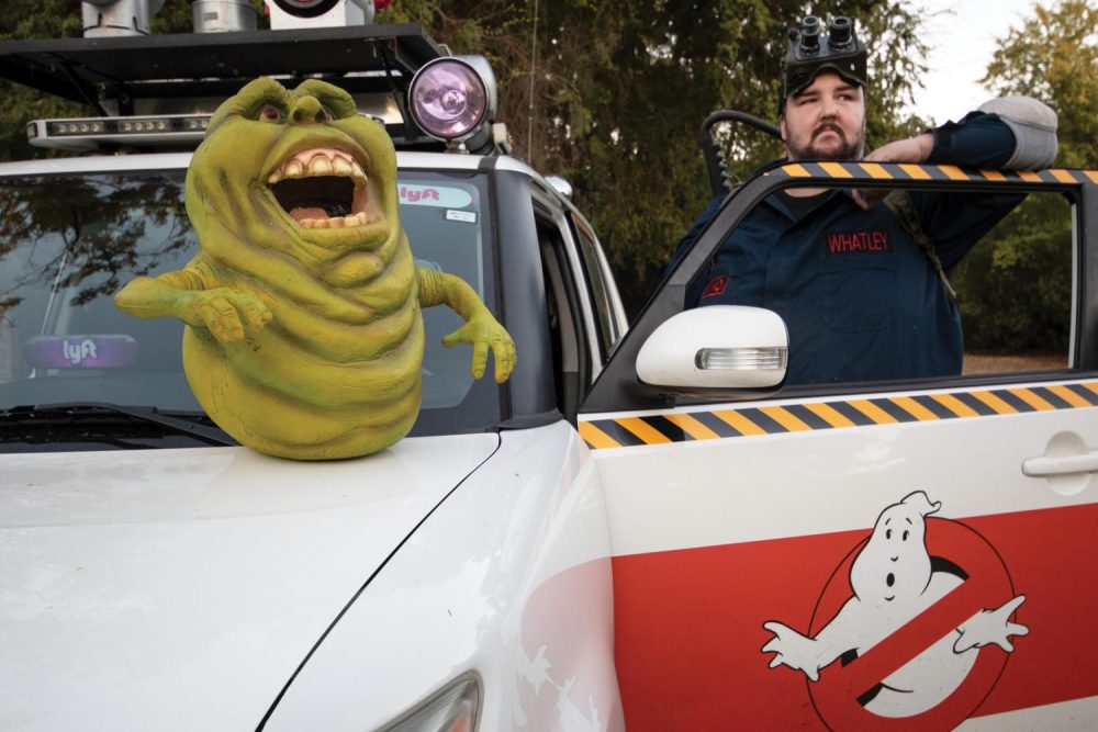 Sacramento Ghostbusters founder Andrew Whatley poses with his Ecto-1 model car and his slimer prop on Oct. 11, 2018. The Sacramento Ghostbusters is a cosplay non-profit organization that attends charity events to help raise awarness of the charity. (Photo by Ashley Hayes-Stone)