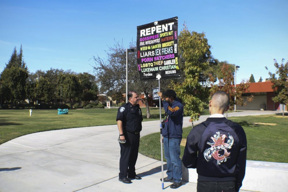 Captain Chris Day from the Los Rios Police Department speaks to a protester in front of the Student Center on Oct. 31, 2018. (Photo by Tracy Holmes)