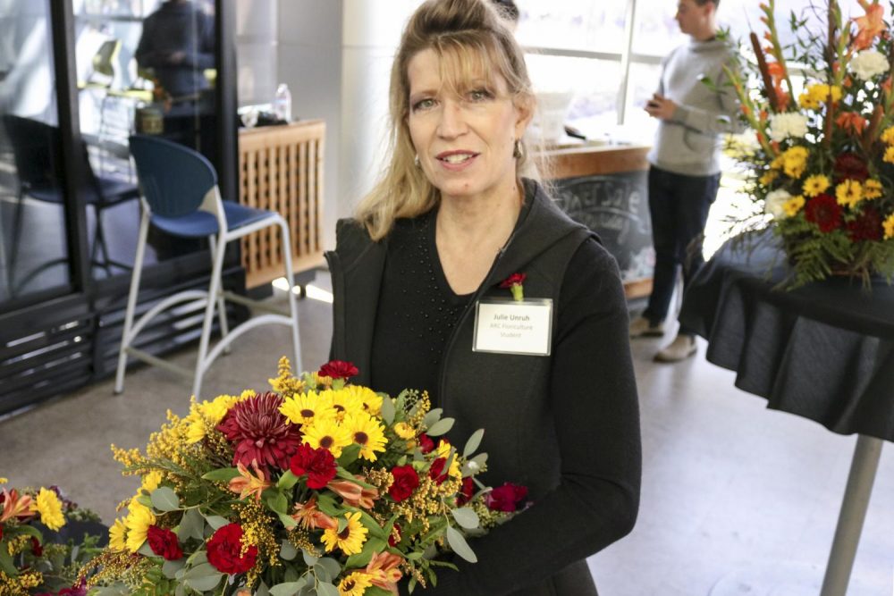 Floriculture student Julie Unruh, sells flowers in the Student Center at American River College on Nov. 08, 2018. (Photo by Christian Sutton)